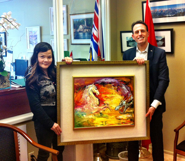 photo of Michelle and John Weston holding the painting